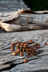 The coffee beans on vintage wooden background.