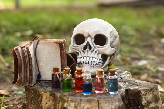 Witch book with mysterious letters and a skull and magic potions