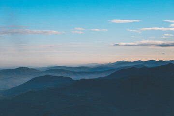 Obraz premium clouds over the mountains at sunrise with blue sky and clouds