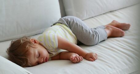 Obraz na płótnie Canvas Candid baby sleeping. One year old infant asleep napping