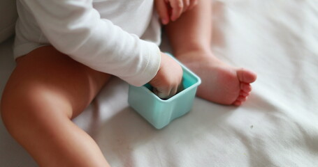 Baby snacking blueberries, cute one year old eating berries