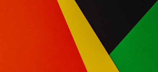 Abstract geometric black, red, yellow, green color paper background. Black History Month color background with copy space for text