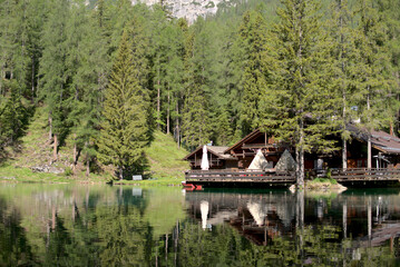 Fototapeta na wymiar House in a lake. Beautiful wood house in the alps