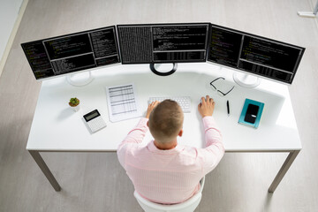 Computer Programmer Writing Program Code On Computer