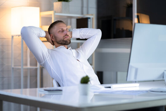 Businessman Sitting In Office Chair Relaxing
