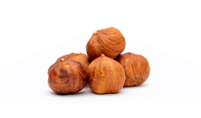 Heap of hazelnuts close-up. Peeled nuts. Hazelnut isolated on white background.