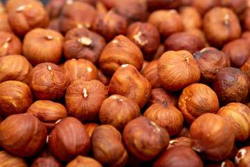 Heap of hazelnuts close-up. Peeled nuts. Hazelnut isolated on white background.