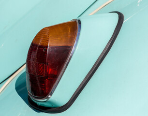 The tail light of a vintage retro car. Retro car brake light. The rear fender of a vintage car is...