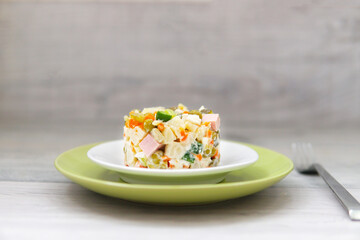 Russian New Year or Christmas salad on light background with copy space.