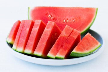 close-up of slices of fresh watermelon served on a grey plate. red Watermelon slices on the white...