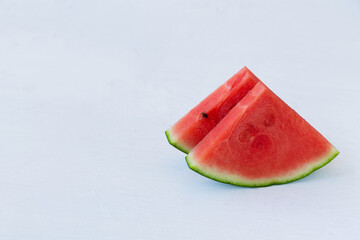 slices of fresh watermelon on the white background. red Watermelon slices on the white table with...