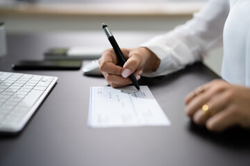 Woman Signing Bank Check