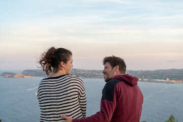 Fototapeta premium Rear view of a happy couple smiling together with copy space