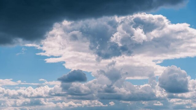 Timelapse of cumulus clouds moving in the blue sky. Fluffy clouds change their shape in cloud space. Awesome sky. Background of cloudscape, time-lapse. Copy space. Change of weather. Nature. 4K