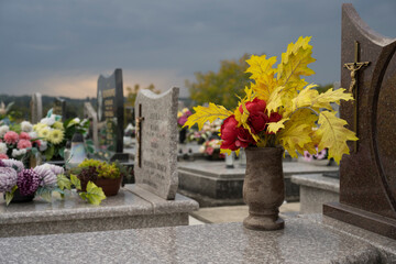 Decoration, candles and flowers on the tombs in cemetery.