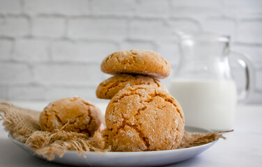 Delicious cookies, milk on old background