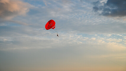 Parasailing on the sea. towed parachute against blue sky. Parachute and boat on the sea at summer....