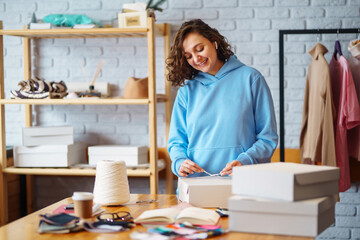 Young woman packing boxes to be shipped.  Оnline store, small business owner, seller, entrepreneur, packing bag, mailbox.