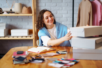 Young woman packing boxes to be shipped.  Оnline store, small business owner, seller, entrepreneur, packing bag, mailbox.