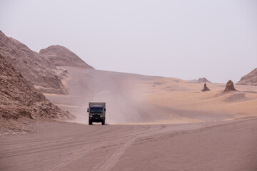 Truck camper in the middle of a sand storm