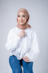 Portrait of a beautiful female Muslim model wearing hijab, a lifestyle apparel for Muslim women isolated on white background. Modern hijab fashion concept.