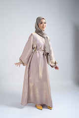 Naklejka premium Portrait of a beautiful female Muslim model wearing hijab, a lifestyle apparel for Muslim women isolated on white background. Modern hijab fashion concept.