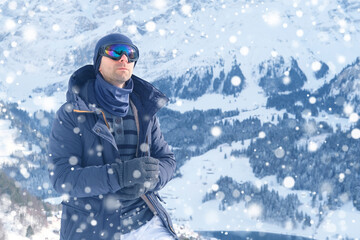 young man wearing sunglasses, mountain hiker admiring mountain winter landscape, Sports Concept, Healthy Lifestyle, Winter Activity, beautiful winter natural landscape, walks in winter white forest