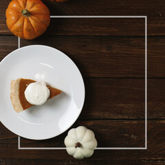 Thanksgiving background with top down view of pumpkin pie on rustic wood background and frame for fall season holiday copy space.