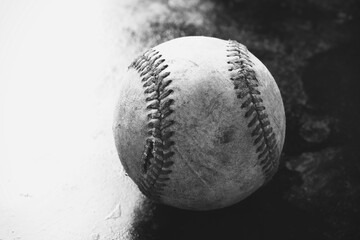 Old used baseball ball detail in black and white with copy space on background.