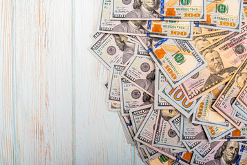 Dollar bills in denominations of 100 and 50. Currency background. Money on a blue wooden background.