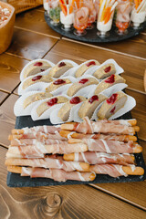 party buffet. little snacks with meat bacon breadsticks. High quality photo