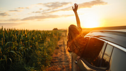 Young woman is resting and enjoying sunset in the car. Lifestyle, travel, tourism, nature, active...