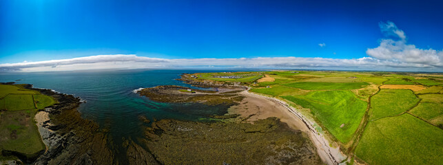 Aerial view of St Cwyfan Church in the sea, Anglesey, Wales. 