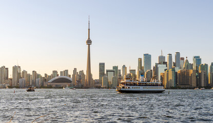 Toronto City downtown skyline at sunset time. Toronto Island Ferry on inner Harbour. Ontario,...