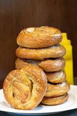 Delicious and mouth-watering pile of fresh homemade salted pretzels full of carbs or carbohydrates for a snack, breakfast or light meal