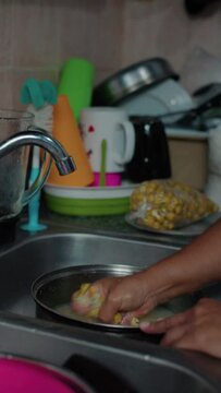 person washing nance in a pot, close up