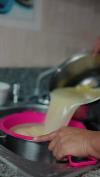 woman brewing nance in a pot, close-up