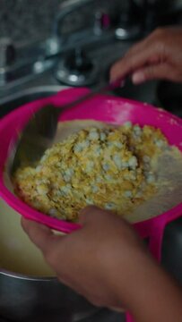 woman brewing nance in a pot, close-up