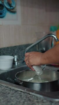 woman preparing heavy nance in a pot, closeup