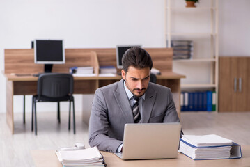 Young male employee working in the office