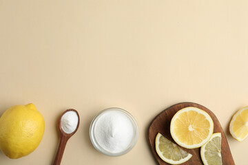 Baking soda and lemons on beige background, flat lay. Space for text
