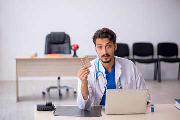 Young male doctor working in the clinic