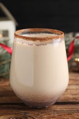 Delicious Christmas liqueur on wooden table, closeup