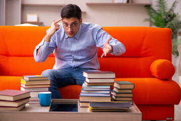 Young male student preparing for exams at home