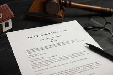 Last will and testament near house model, glasses, gavel on black table, closeup
