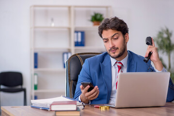 Young male employee and too much work in the office
