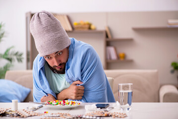 Young sick man suffering at home