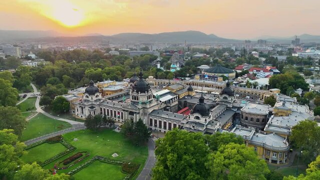 4K aerial drone view Szechenyi Bath. Drone flies around pool with many visitors. Budapest, Hungary