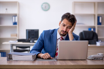 Young male employee working in the office