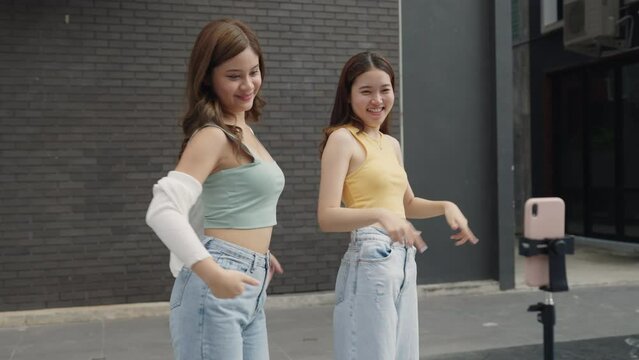 Gen z vlogger influencer asia teen girl trending relax smile moving dance at city park street record on social app young youtuber play fun joy selfie post show share viral vlog video
